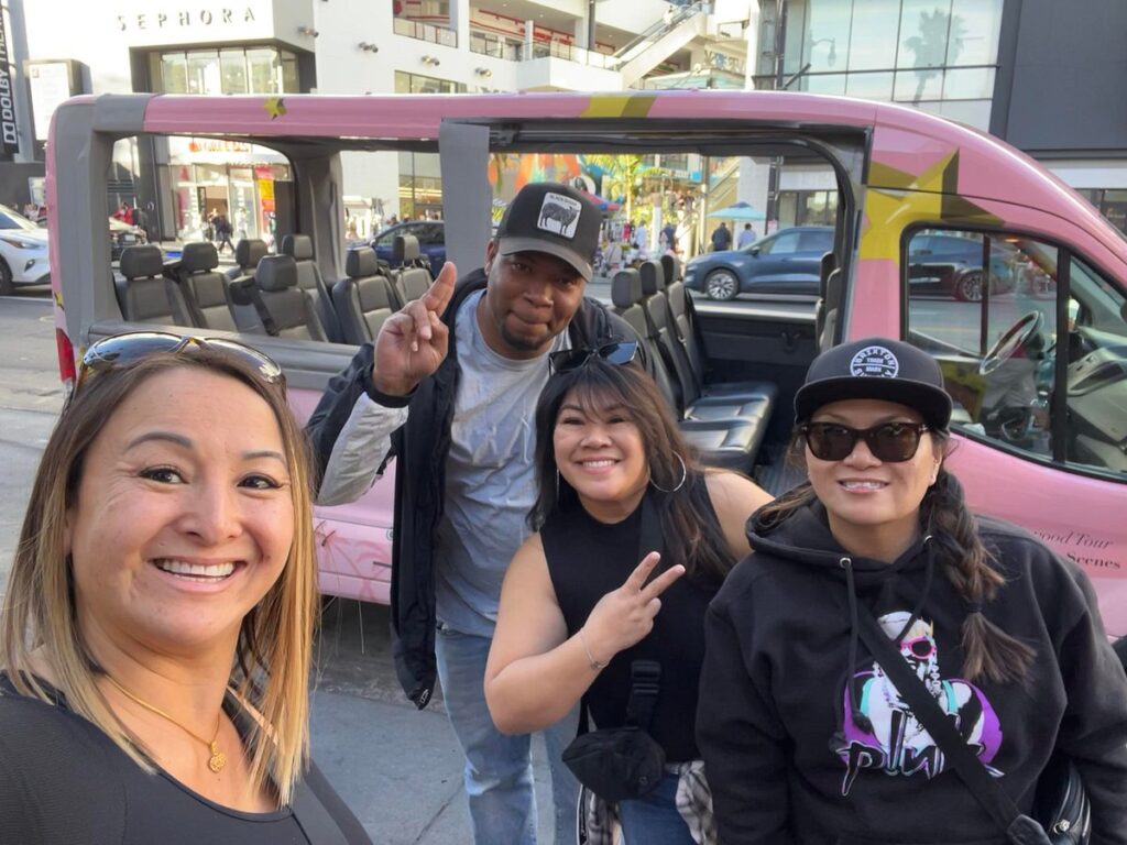 pink van with 3 customers