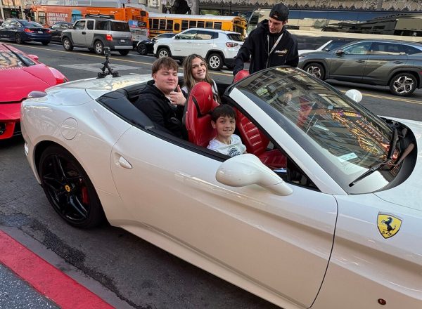 Family enjoying a Ferrari convertible experience on Hollywood Boulevard, one of the most exciting things to do in Los Angeles.