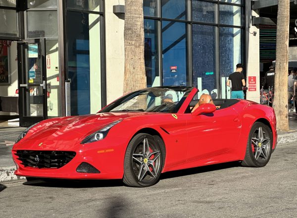 Red Ferrari California convertible driving through Hollywood, one of the most exciting things to do in Los Angeles.