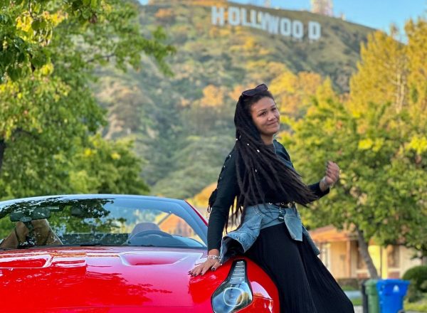 Woman red ferrari hollywood sign Los Angeles driving experience ride like a star